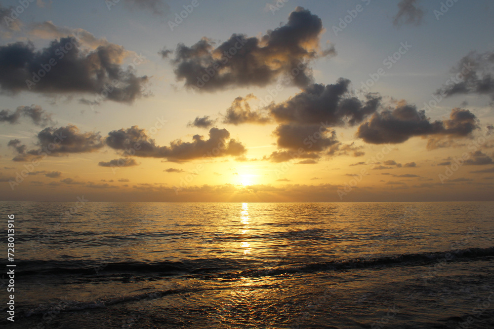 natural background of cloudy sky and sunset over the sea