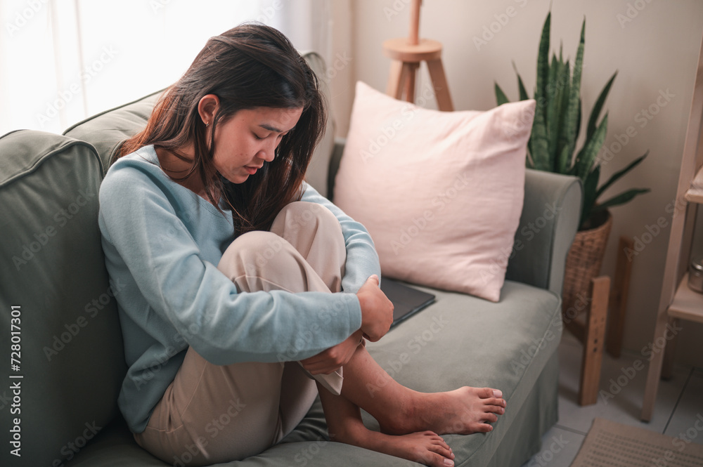 Obraz premium sad, depression, unhappy, depressed, lonely, problem, upset, alone, sofa, bad. depressed young woman sitting on couch in home, frustrated confused female feels unhappy problem in personal life.