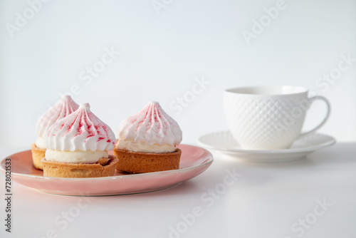 cupcakes with cup of coffee on white table