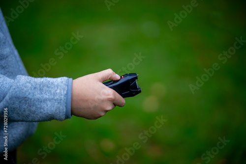 A stun gun for self-defense. Legal protection from robbers. An electric shocker in the hands of a child. photo