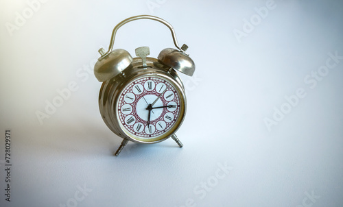 Vintage retro alarm clock on a white table.Wake up early in the morning.A mechanical clock on the table.