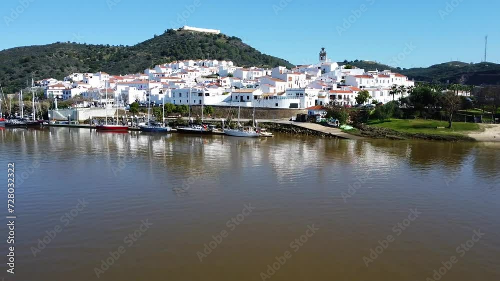 Aerial drone view of Sanlucar de Guadiana village in Huelva, Andalusia, on the banks of Guadiana river, in the border of spain with portugal, in front of the portuguese village of Alcoutim in Algarve Aerial drone view of Sanlucar de Guadiana village in Huelva, Andalusia, on the banks of Guadiana river, in the border of spain with portugal, in front of the portuguese village of Alcoutim in Algarve