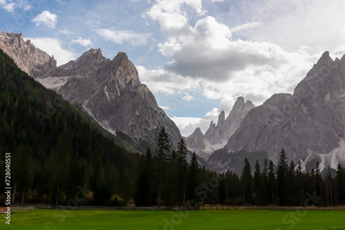 Scenic view of majestic rugged mountain peaks of Sexten Dolomites, Bolzano, South Tyrol, Italy, Europe. Hiking in panoramic Fischleintal near Moos, Italian Alps. Idyllic conifer forest. Tranquil scene