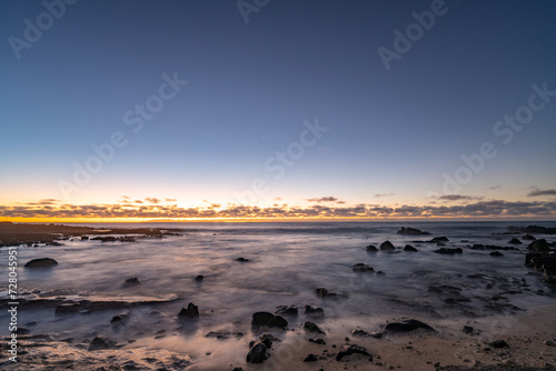 Wallpaper Mural Sunrise on the Kaloko Beach in Honolulu Oahu Hawaii. wilight is light produced by sunlight scattering in the upper atmosphere, when the Sun is below the horizon, which illuminates the lower atmosphere Torontodigital.ca