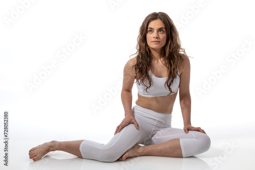Young thoughtful woman ready to permorm yoga on a white background