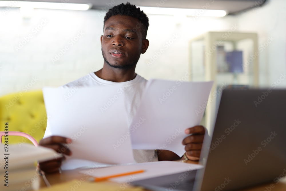 A successful businessman in a modern office, working on a laptop, embodying a professional and determined demeanor. A successful businessman in a modern office, working on a laptop, embodying a professional and determined demeanor.