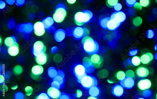 intentionally blurred background of many colorful lights of blue green azure colors ideal as abstract or dreamy background