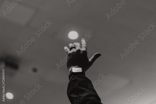 Silhouette of hand raised in air, Praising hand