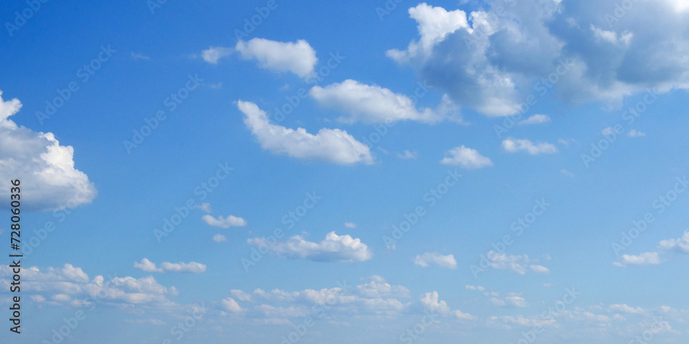 The sky is bright and blue, dotted with numerous white clouds. The sky is bright and blue, dotted with numerous white clouds.