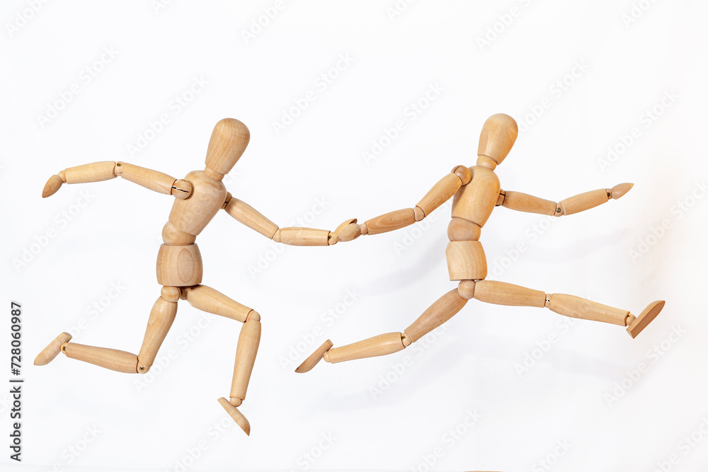 Wooden men in motion. The concept of people's relationships. Friends.Wooden doll Used to simulate human gestures. Wooden men in motion. The concept of people's relationships. Friends.Wooden doll Used to simulate human gestures.