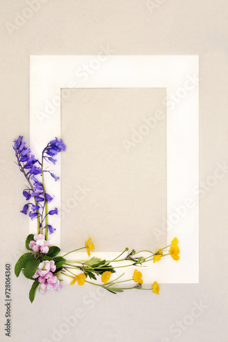Spring flower background frame with bluebell, apple blossom and buttercup flowers. Floral Beltane nature seasonal design with cream border on hemp paper.