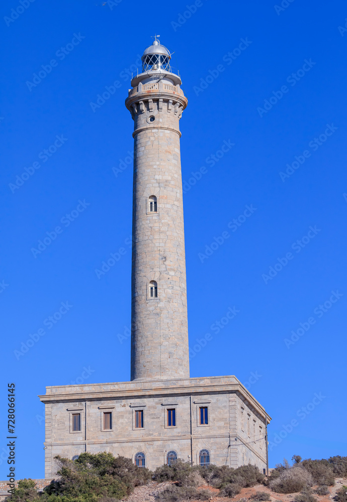 Tall stone built lighthouse on a hill