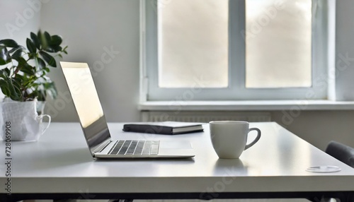 office desk table with laptop and cup