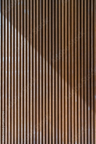 Fototapeta Naklejka Na Ścianę i Meble -  Crop of luxury room wall decorated with panels made of natural wood. Vertical timber slats texture used in minimalistic interior design for simple and elegant effect