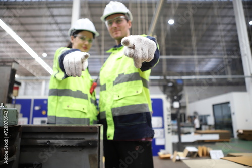 worker or engineer working in factory with safety uniform , safety hat and safety glasses , image is safety concept or happy workplace