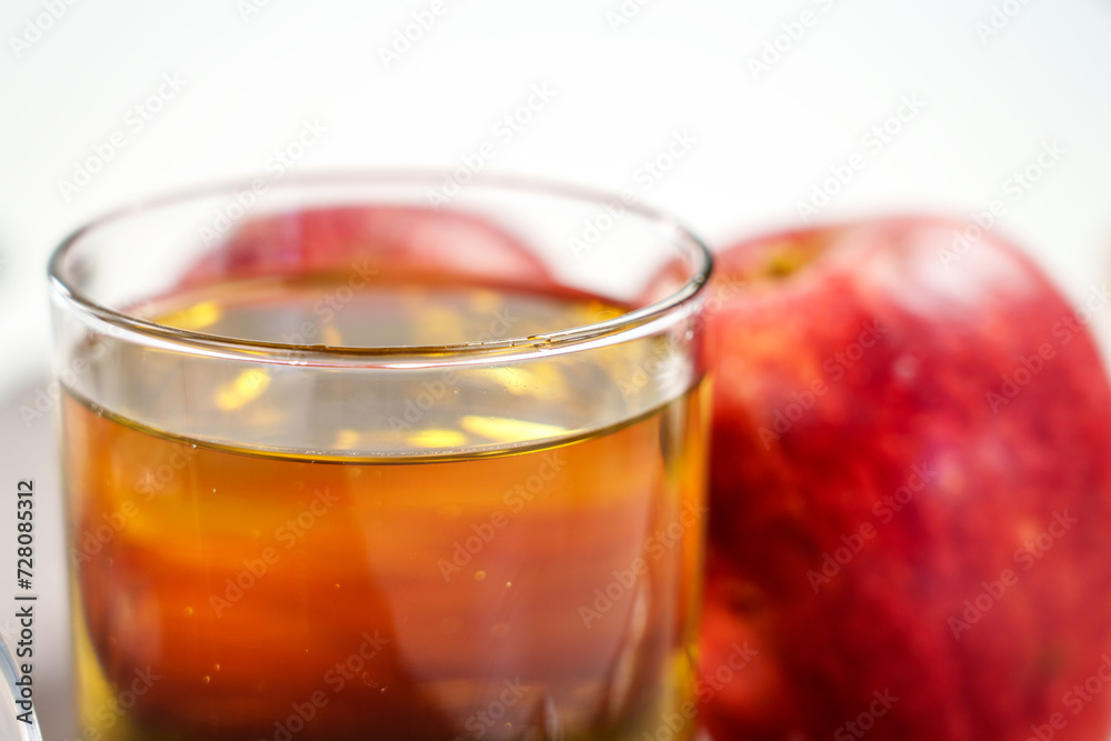 Apple cider on table with red organic apples close up. Apple cider on table with red organic apples close up.
