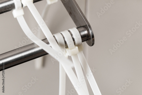 Obraz na plátně Fixed plastic cable ties on a steel structure