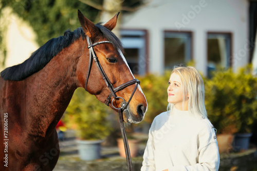 Horse and young blonde woman in head portraits.