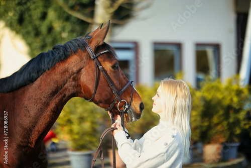Horse and young blonde woman in head portraits.