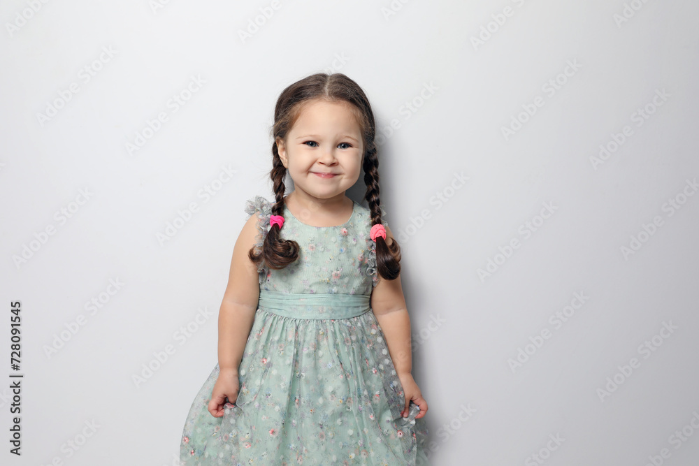 Cute little girl on light grey background Cute little girl on light grey background