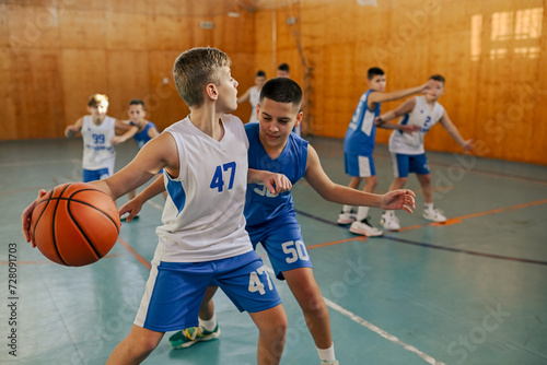 Fototapeta Naklejka Na Ścianę i Meble -  Junior basketball team is practicing game at indoor court.