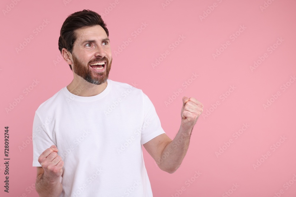 Portrait of happy surprised man on pink background, space for text Portrait of happy surprised man on pink background, space for text
