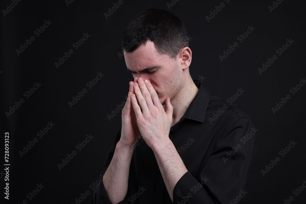 Portrait of sad man on black background, space for text Portrait of sad man on black background, space for text