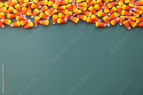 Candy corn on green background photo