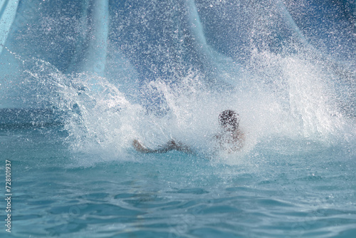 Group of People Swimming in Pool Next to Water Slide © justoomm