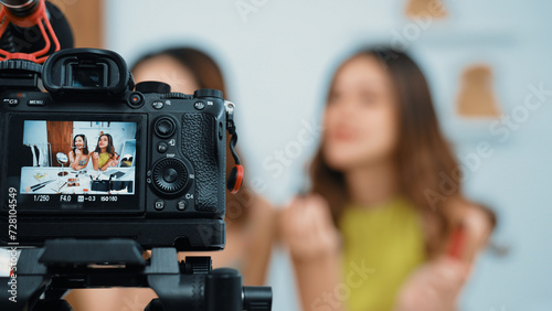 Two influencer partner shoot live streaming vlog video review makeup social media or blog. Happy young girl with vivancy cosmetics studio lighting for marketing recording session broadcasting online. © Summit Art Creations