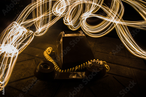 old black telephone on old wood plank with art dark background with fog and toned light. empty space.