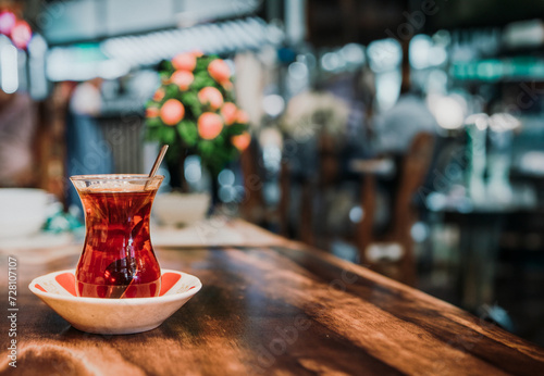 Photography Turkish black tea in glass cup on wooden table