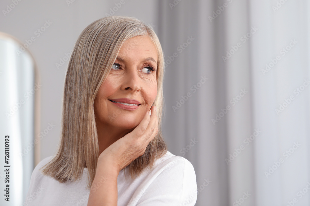 Portrait of beautiful middle aged woman indoors. Space for text Portrait of beautiful middle aged woman indoors. Space for text