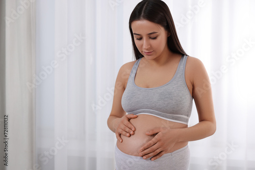 Beautiful pregnant woman in comfortable maternity underwear indoors, space for text Free Download Beautiful pregnant woman in comfortable maternity underwear indoors, space for text - GFXLoad