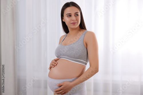Free Download Beautiful pregnant woman in comfortable maternity underwear indoors - GFXLoad