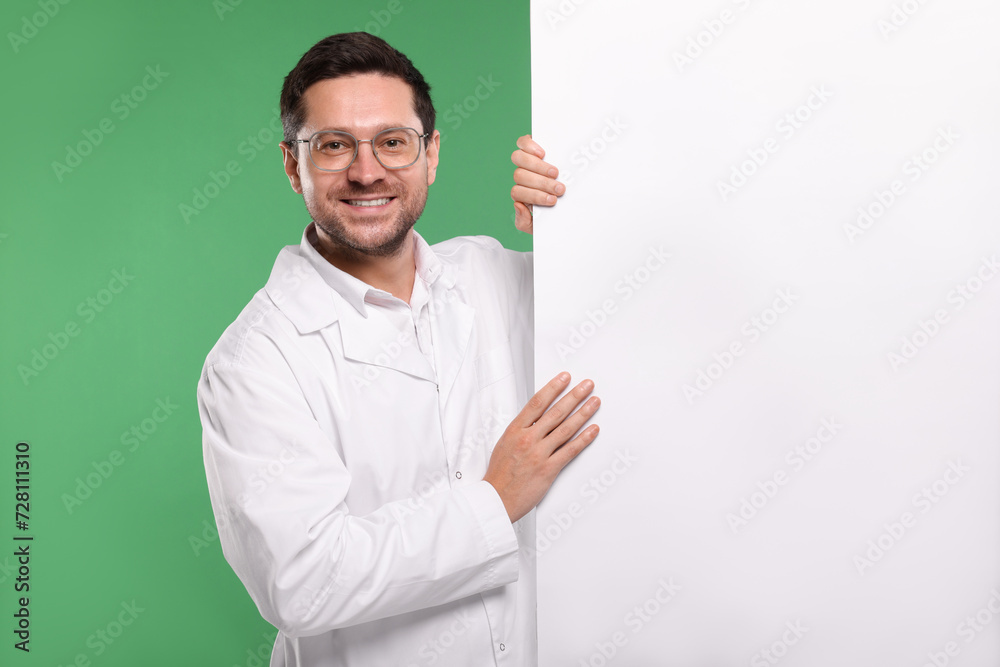Ophthalmologist with blank banner on green background, space for text Ophthalmologist with blank banner on green background, space for text
