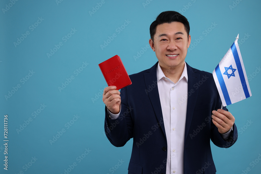 Immigration. Happy man with passport and flag of Israel on light blue background, space for text Immigration. Happy man with passport and flag of Israel on light blue background, space for text