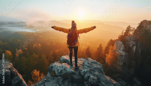 Adventurous Hiker Embracing Sunrise on Mountain Peak