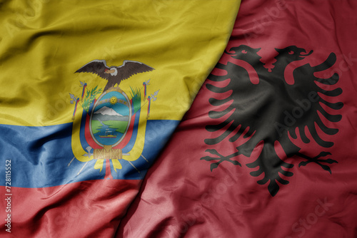 big waving national colorful flag of albania and national flag of ecuador .