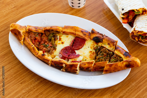 Pide with minced meat, vegetables and cheese. Turkish cuisine photo