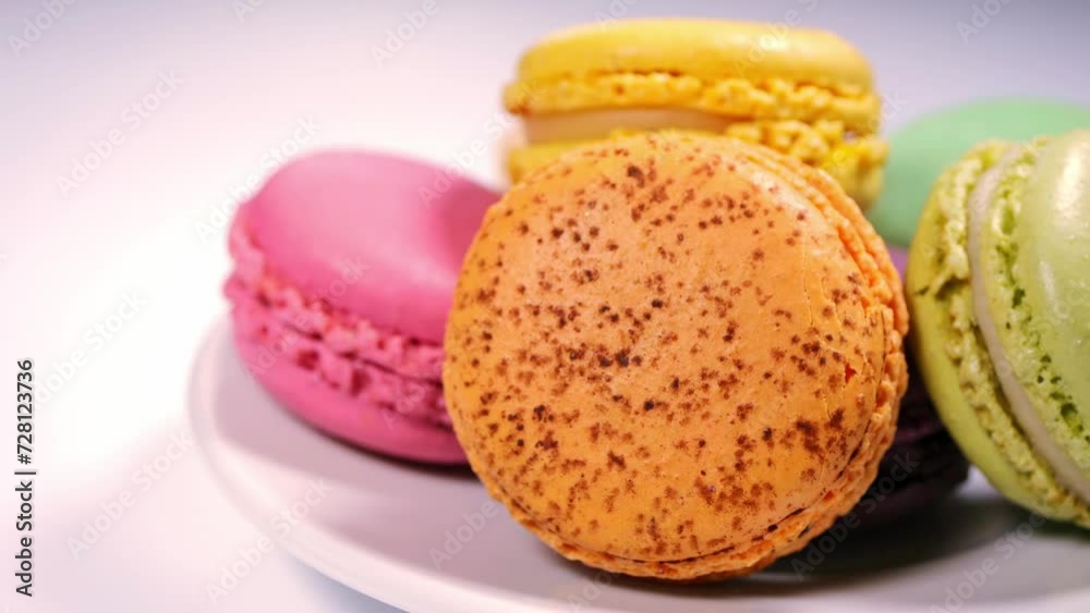 Close-up of colorful macarons cakes on white plate. macaroon desserts and sweets. sugar consumption Close-up of colorful macarons cakes on white plate. macaroon desserts and sweets. sugar consumption