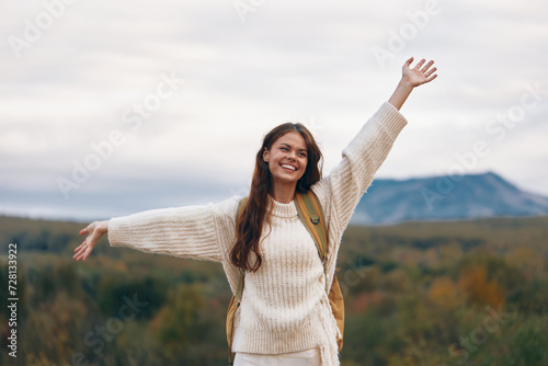 Mountain Adventure: Smiling Woman on Cliff, Enjoying Outdoor Exploration