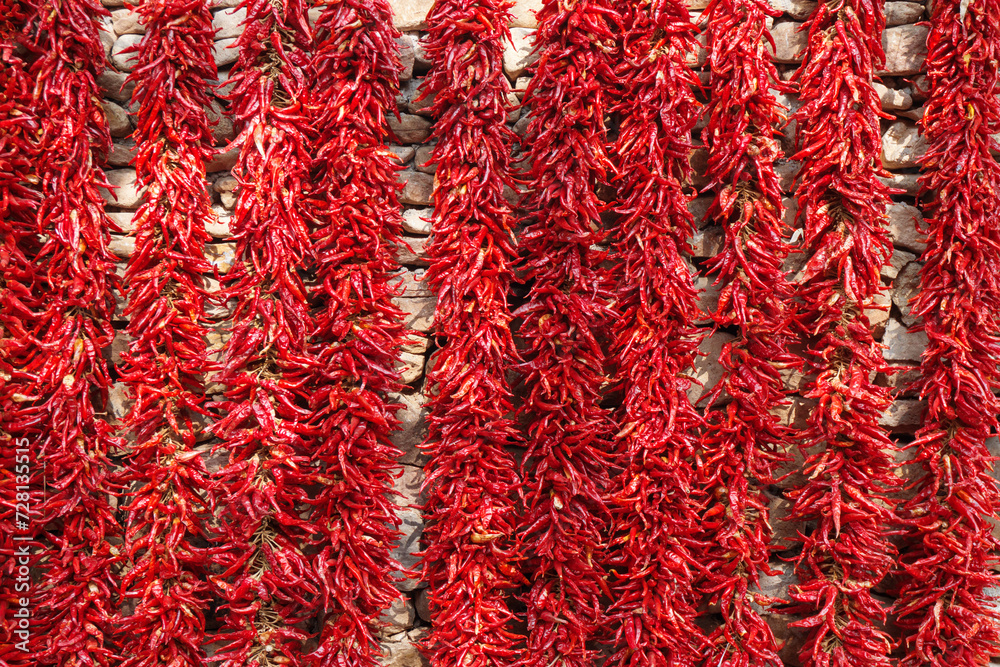 Chili peppers on a stone wall in Zhuquan village, Yinan County, Linyi City, Shandong province Chili peppers on a stone wall in Zhuquan village, Yinan County, Linyi City, Shandong province