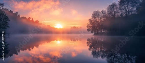 Mystical Morning Fog Embraces Serene Lake During Mesmerizing Sunrise Shot
