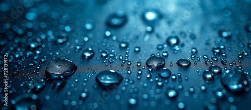 Water Drops in a Dark Blue Background: A Mesmerizing display of Water Drops creating an Enchanting Dark Blue Ambiance