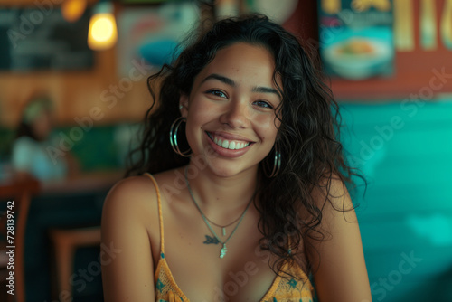 young hispanic woman in a restaurant bar smiling teenager latina happy joyful strappy top bare shoulders brown curly hair bokeh background lights blue warm chairs pretty beautiful twenties tanned Free Download young hispanic woman in a restaurant bar smiling teenager latina happy joyful strappy top bare shoulders brown curly hair bokeh background lights blue warm chairs pretty beautiful twenties tanned - GFXLoad