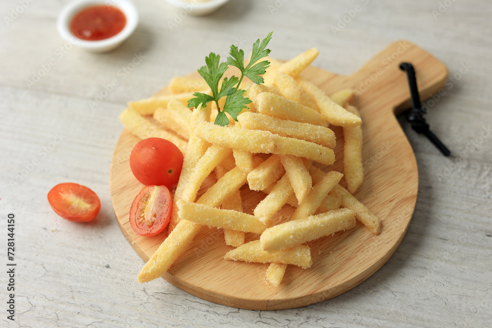 French Fries Served on Wooden Board Coating with Spice and Salt. French Fries Served on Wooden Board Coating with Spice and Salt.