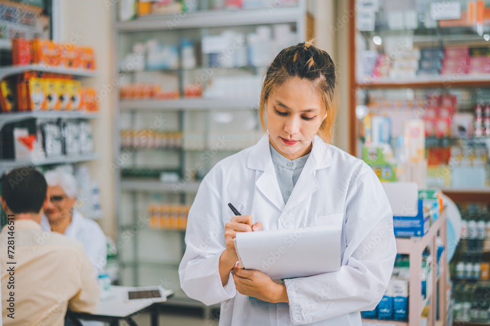 Pharmacist checking Checks Inventory of Medicine, Drugs, Vitamins with tablet and checking patient's prescription in modern pharmacy.