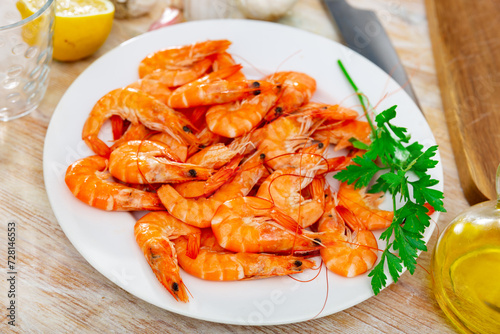Seafood appetizer. Roasted langostins served with parsley and lemon