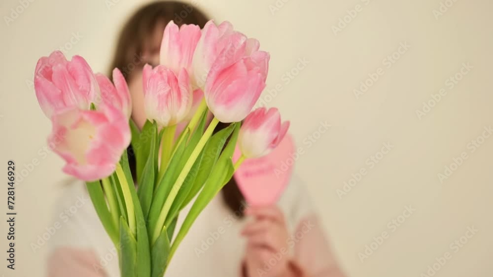Mothers Day. daughter gives her mother a bouquet of pink tulips and a pink heart. 4k footage Mothers Day. daughter gives her mother a bouquet of pink tulips and a pink heart. 4k footage